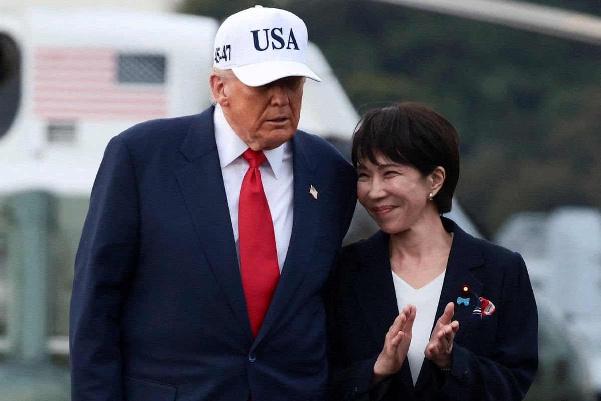 President Donald Trump walks with Japanese Prime Minister Sanae Takaichi, aboard the aircraft carrier USS George Washington, during a visit to U.S. Navy's Yokosuka base in Yokosuka, Japan, October 28, 2025.