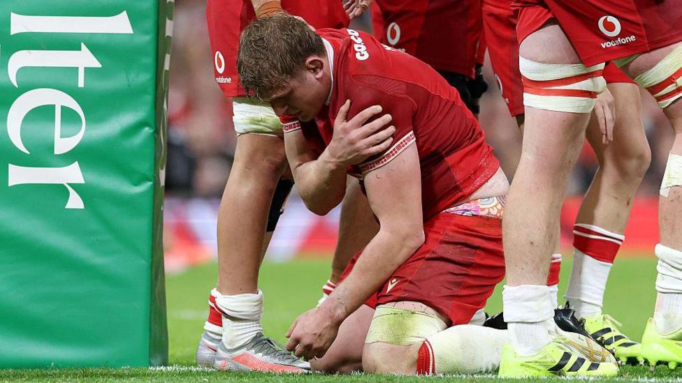 Jac Morgan holds his shoulder after getting injured scoring for Wales against Argentina
