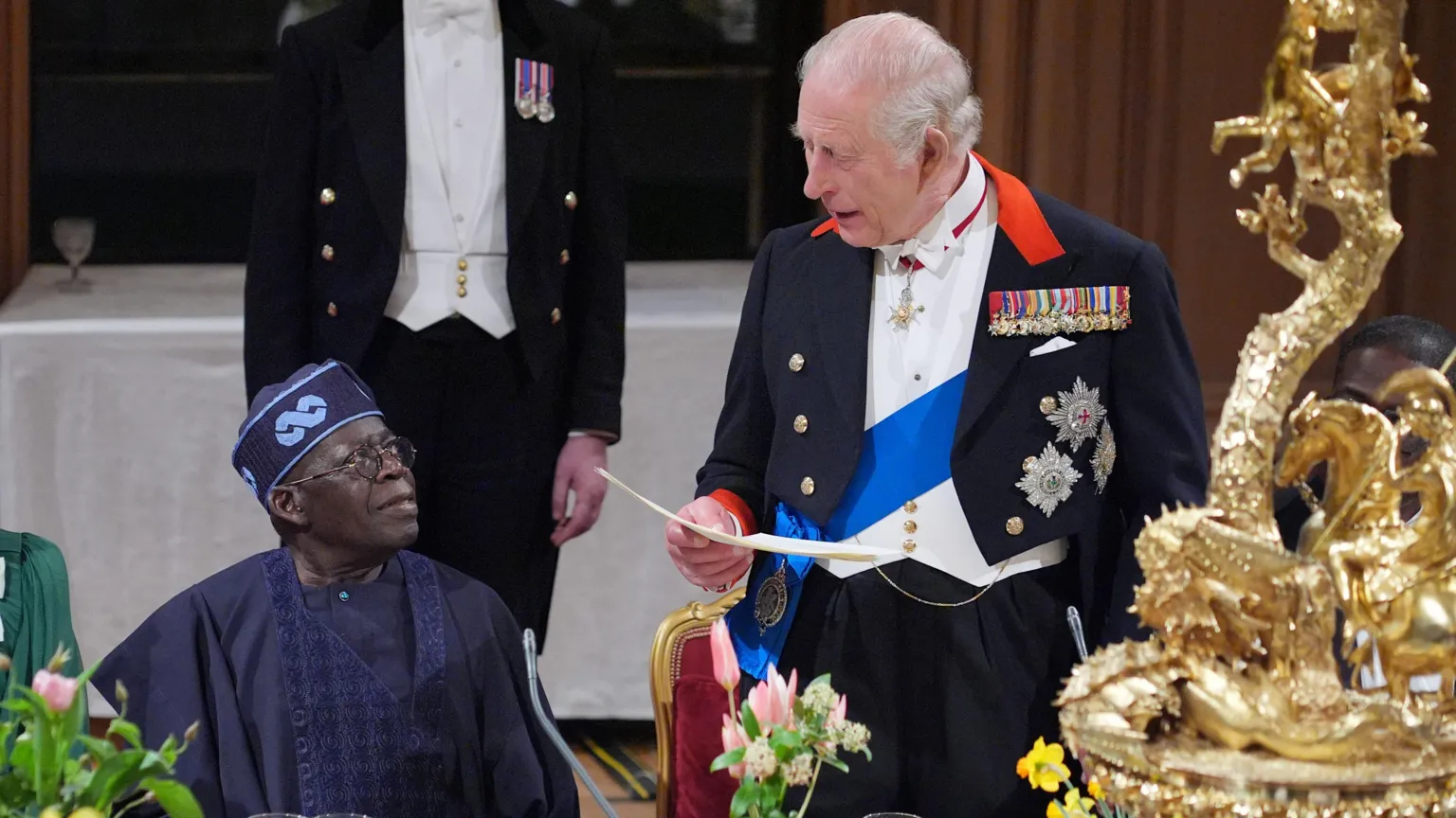  King Charles delivers his speech as President Tinubu sits listening beside him during a state banquet at Windsor Castle