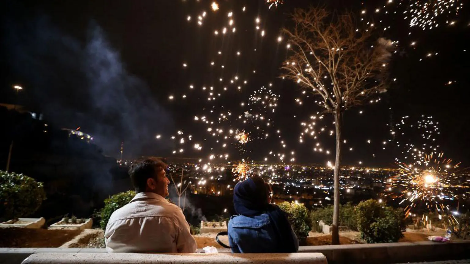 AFP via Iranians watch fireworks during the Wednesday Fire feast, or Chaharshanbeh Soori, held annually on the last Wednesday eve before the Spring holiday of Nowruz, in Tehran, on March 18, 2025. 