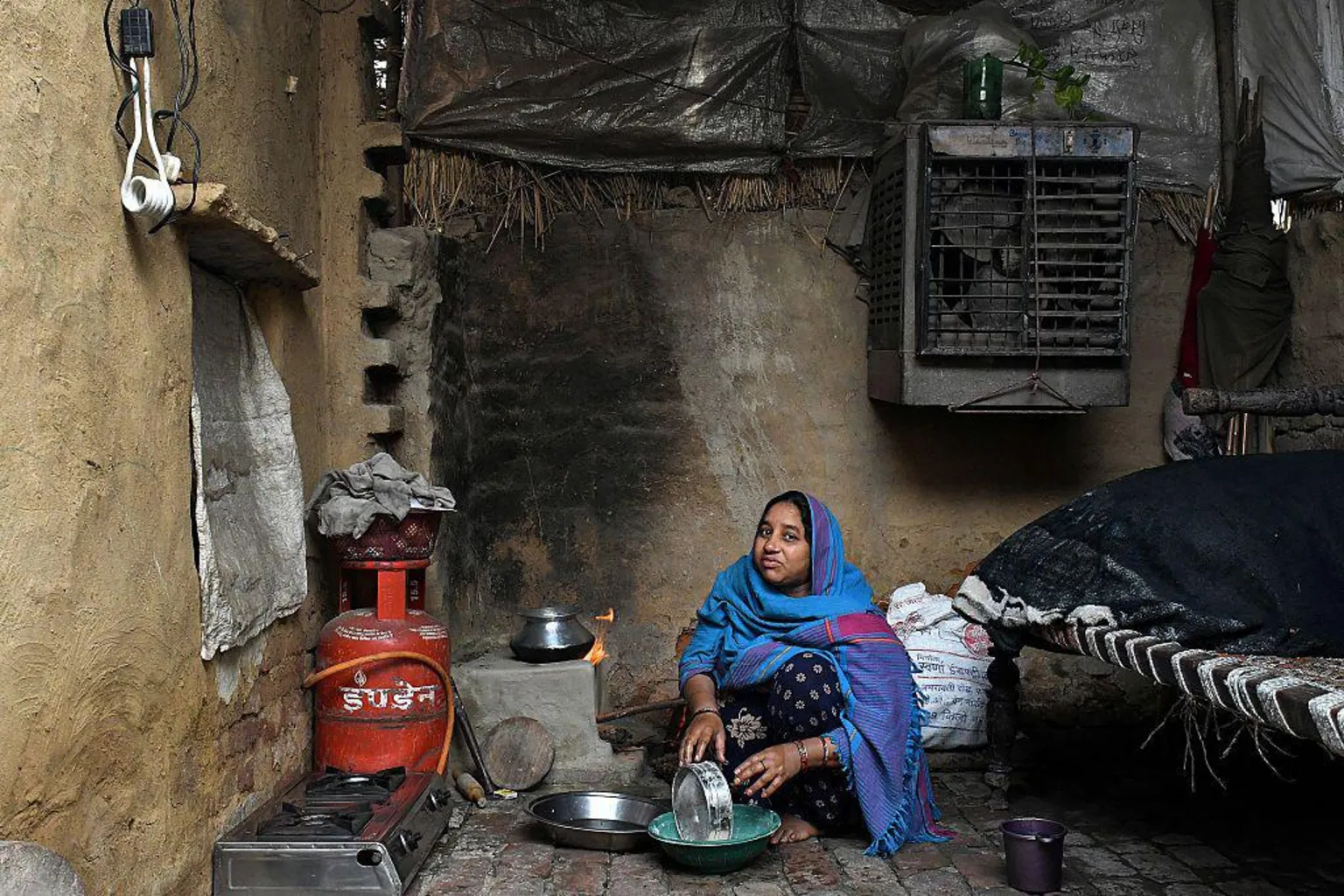 Bloomberg via A woman prepares food to be cooked on a liquefied petroleum gas (LPG) connected stove at her home in a village near Modinagar, Uttar Pradesh, India, 