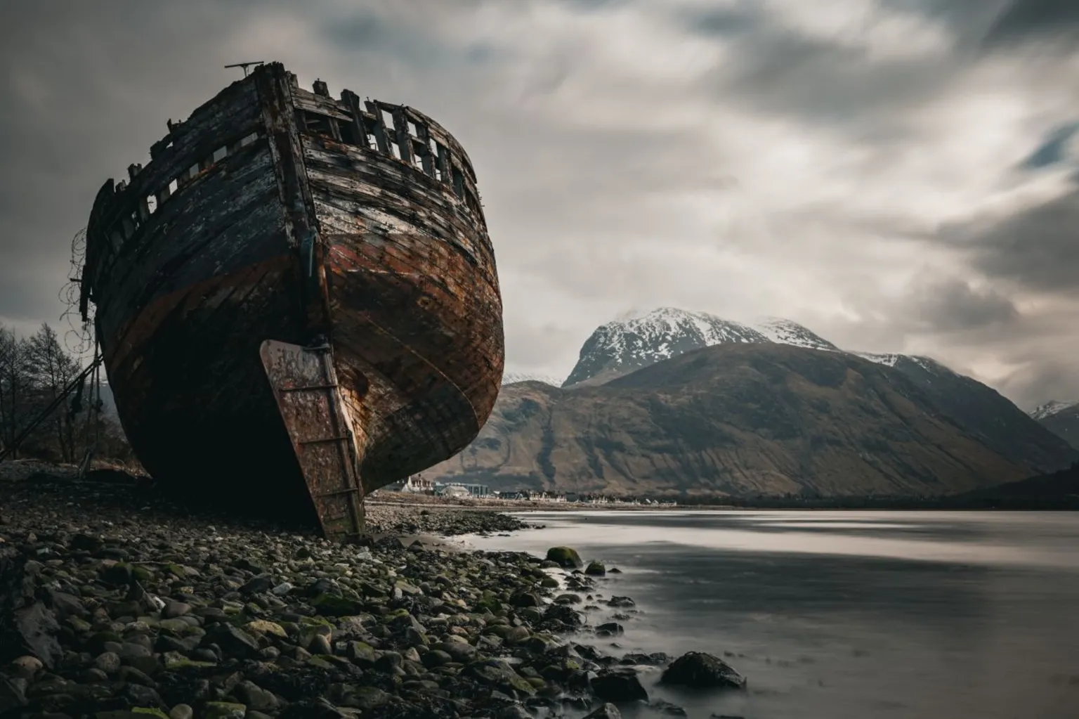 Jon Simmonds A shipwreck on the bank of a loch with a mountain in the background