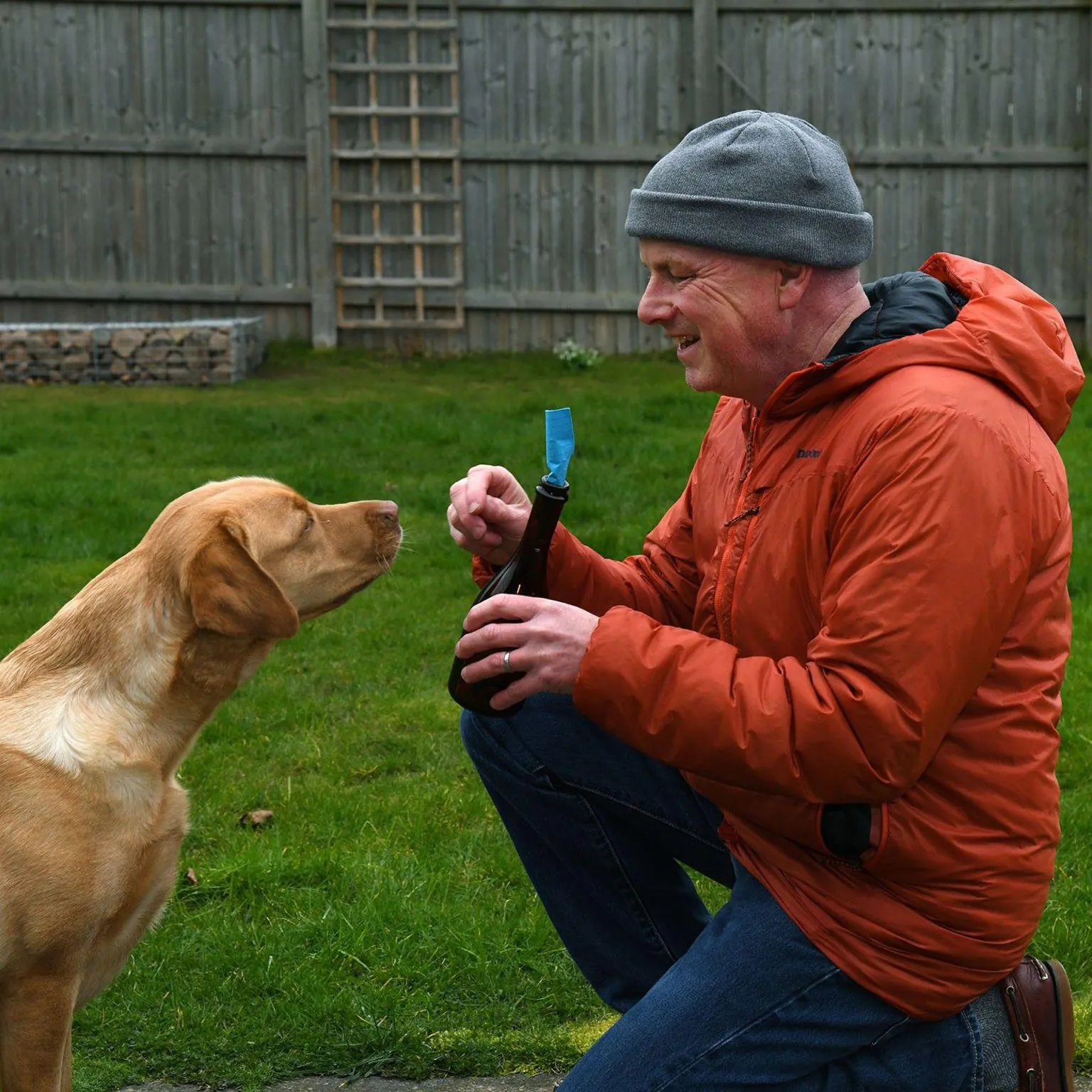 Mike Scott Maggie the dog, a golden labrador, with owner Mike Scott, and the brown bottle and blue letter they found.