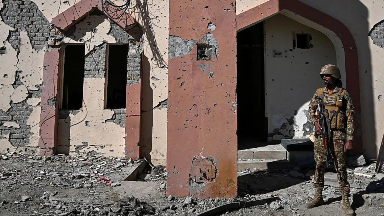 AFP A Pakistani serviceman stands in front of the damaged entrance after an attack on the Cadet College Wana, a military-linked school, in the South Waziristan district near the Pakistan-Afghanistan border, on November 13, 2025.