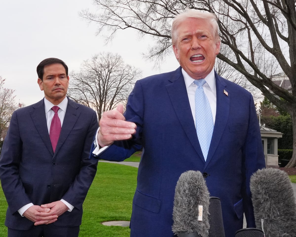 Donald Trump speaking into microphones as he takes questions from reporters