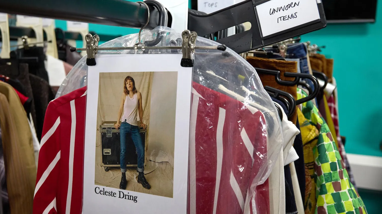 Sky Various studio outfits for Celeste Dring hang on a clothing rail backstage.