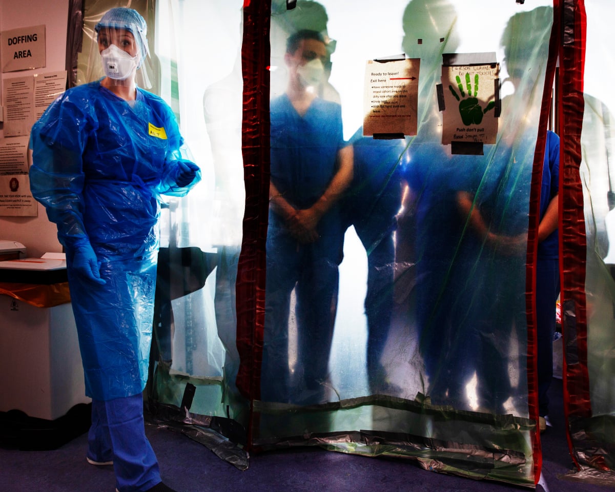 Doctors remove PPE after treating Covid patients in a stretched intensive care unit at the Western General hospital, Edinburgh.