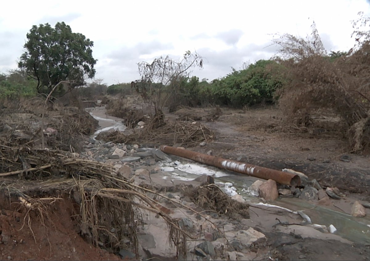 The bed of a small river showing damage and debris similar to a flood sweeping along