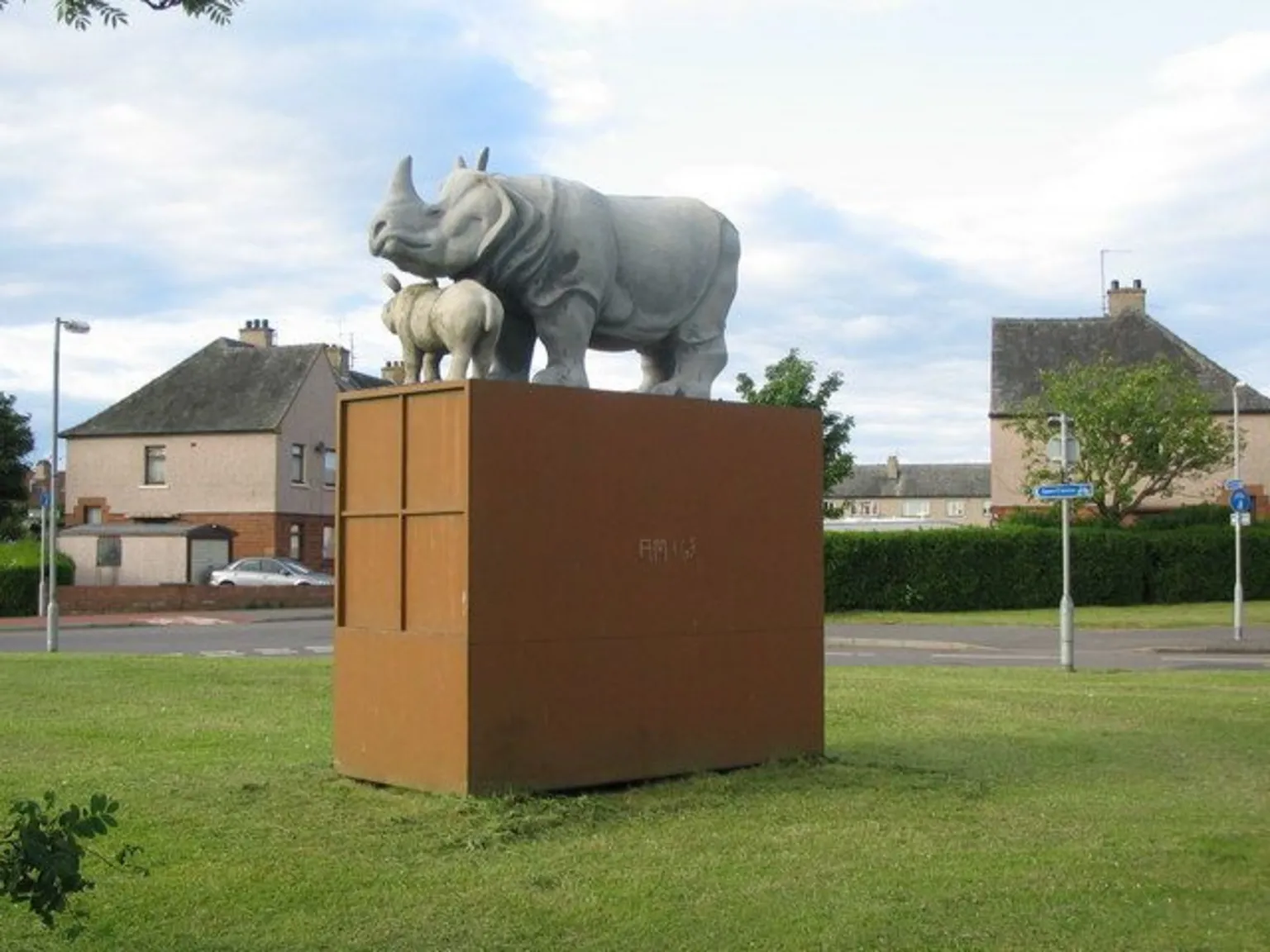 Phil Williams The rhino and baby statue on top of a brown, box-shaped plinth