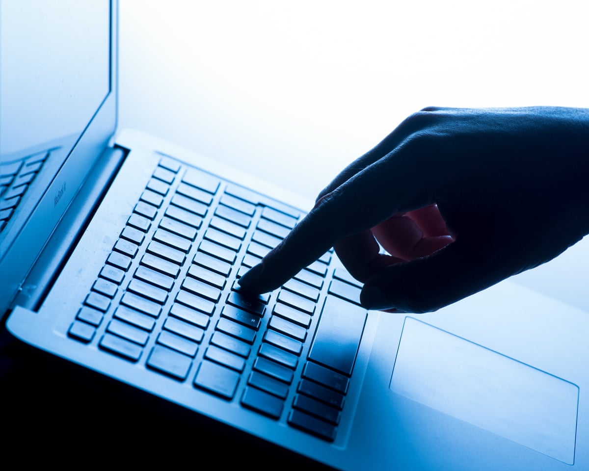 a hand taps a message on a laptop