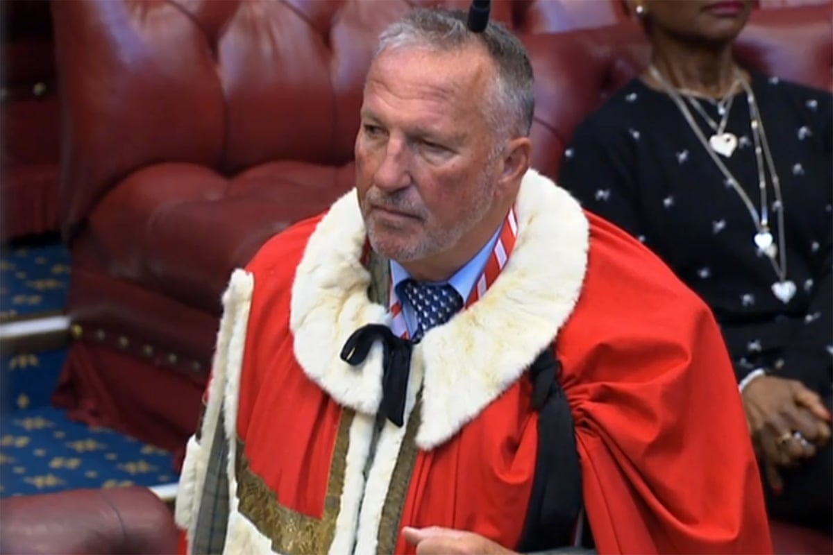 Ian Botham in the House of Lords: he is wearing a ceremonial red robe with white fur collar.