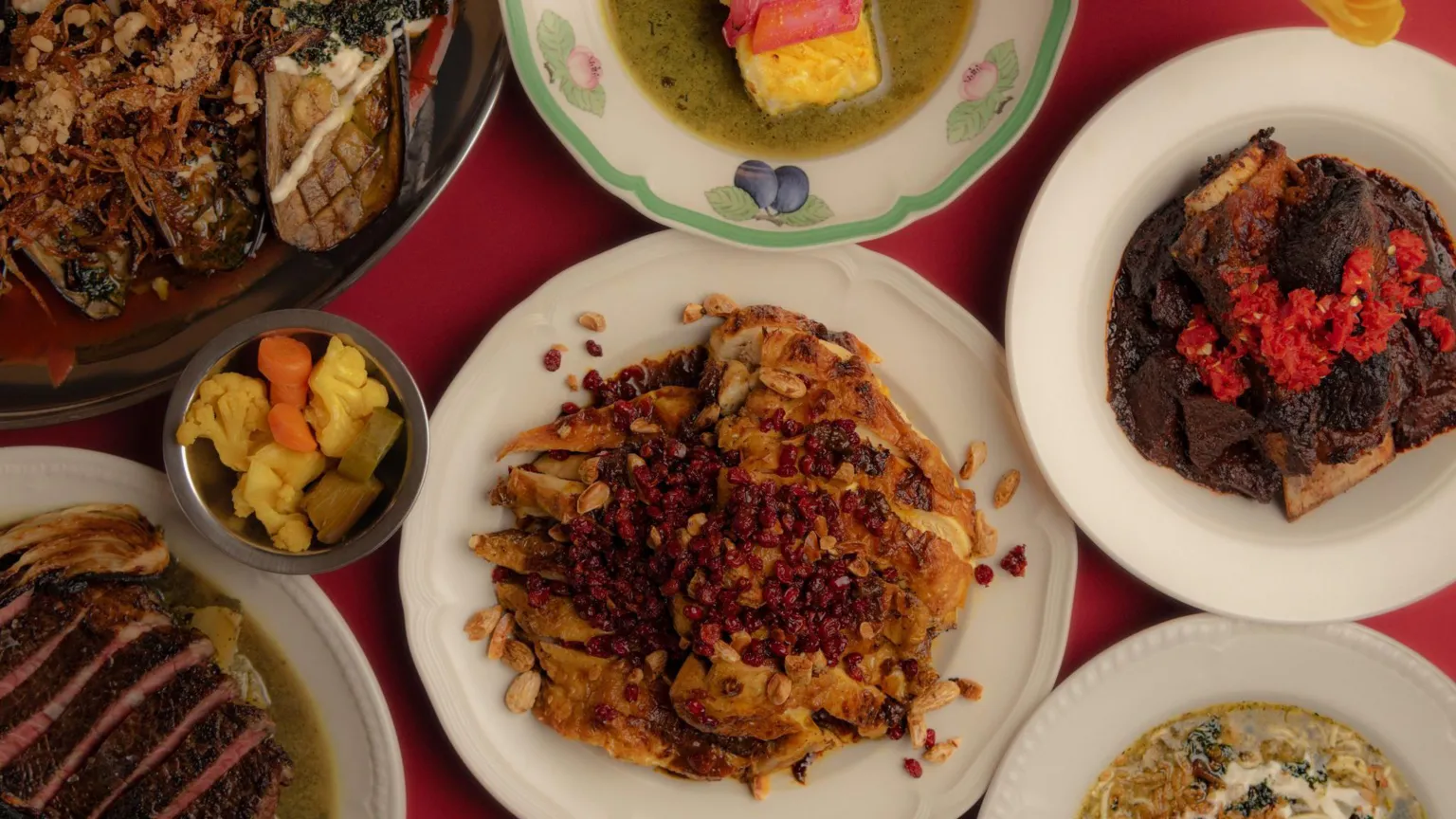 Rebecca Dickson A shot of several dishes of Iranian food on the table arranged in separate plates