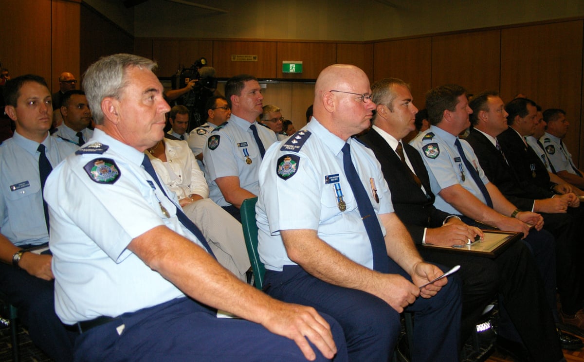 Then Queensland police officer Darren Robinson, third from left in suit, at an awards ceremony in 2008