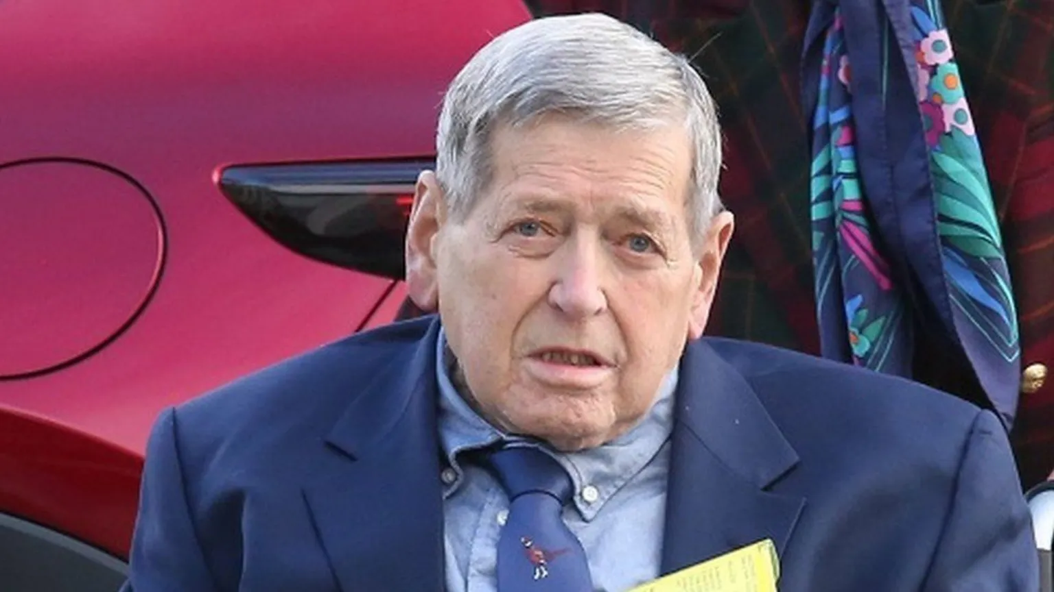 Peter Jolly Northpix William MacDowell is an older man with grey/white hair. He is wearing a dark blue suit jacket over a light blue shirt and dark blue tie.