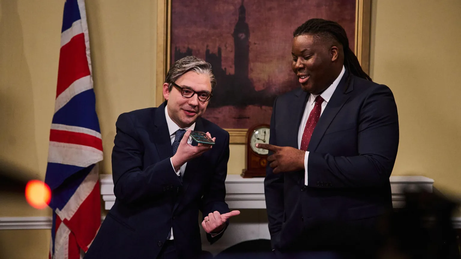 Sky UK Two actors in a set resembling Ten Downing Street - one is appearing as Keir Starmer, the other as David Lammy, both wearing suits. A Union Flag and painting of Big Ben are behind them