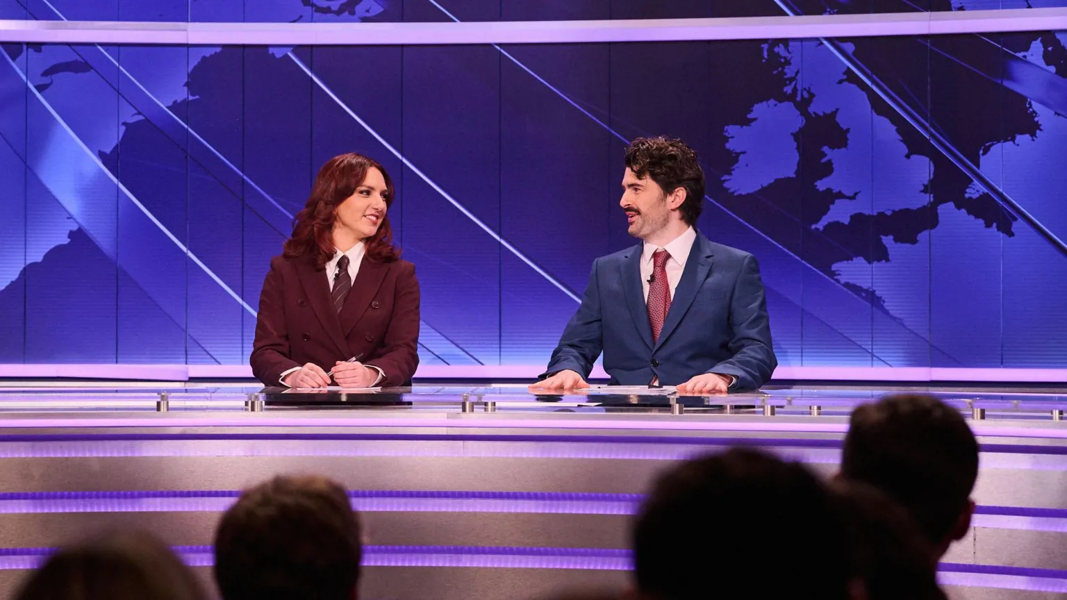 Sky UK Ania Magliano and Paddy Young as news anchors at a set with a map of the world seen behind them