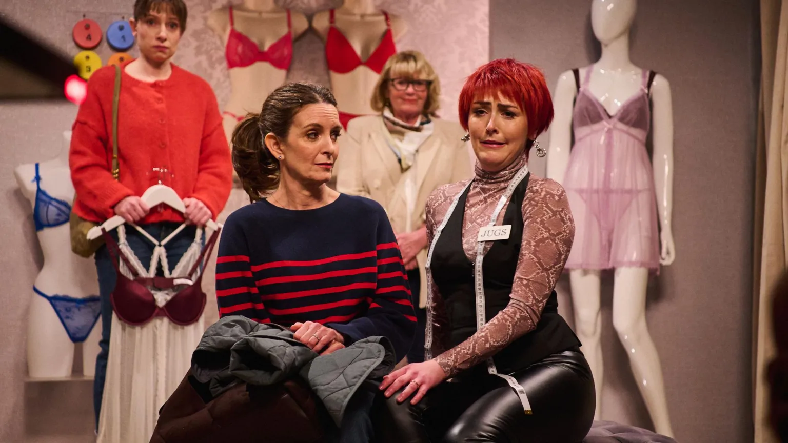 Sky UK Tina Fey and Emma Sidi, wearing a cropped red wig, in the changing rooms of a women's underwear shop
