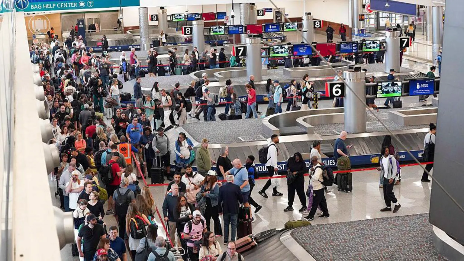 Travellers stand in long lines which are snaking around baggage carousels at Atlanta Hartsfield-Jackson International Airport on March 22, 2026 in Atlanta, Georgia.