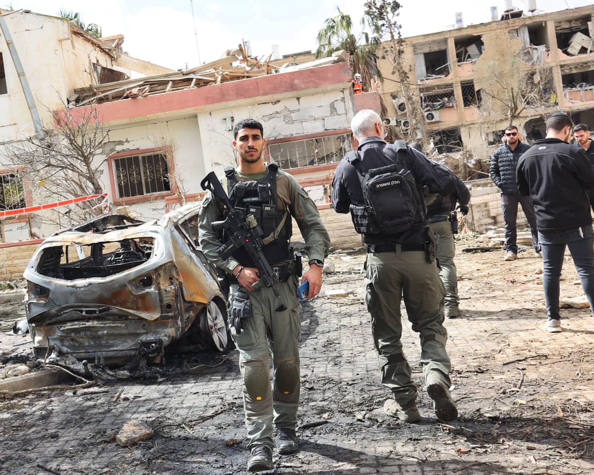 Security forces and rescue teams search the scene of Iranian strike in Dimona, Israel