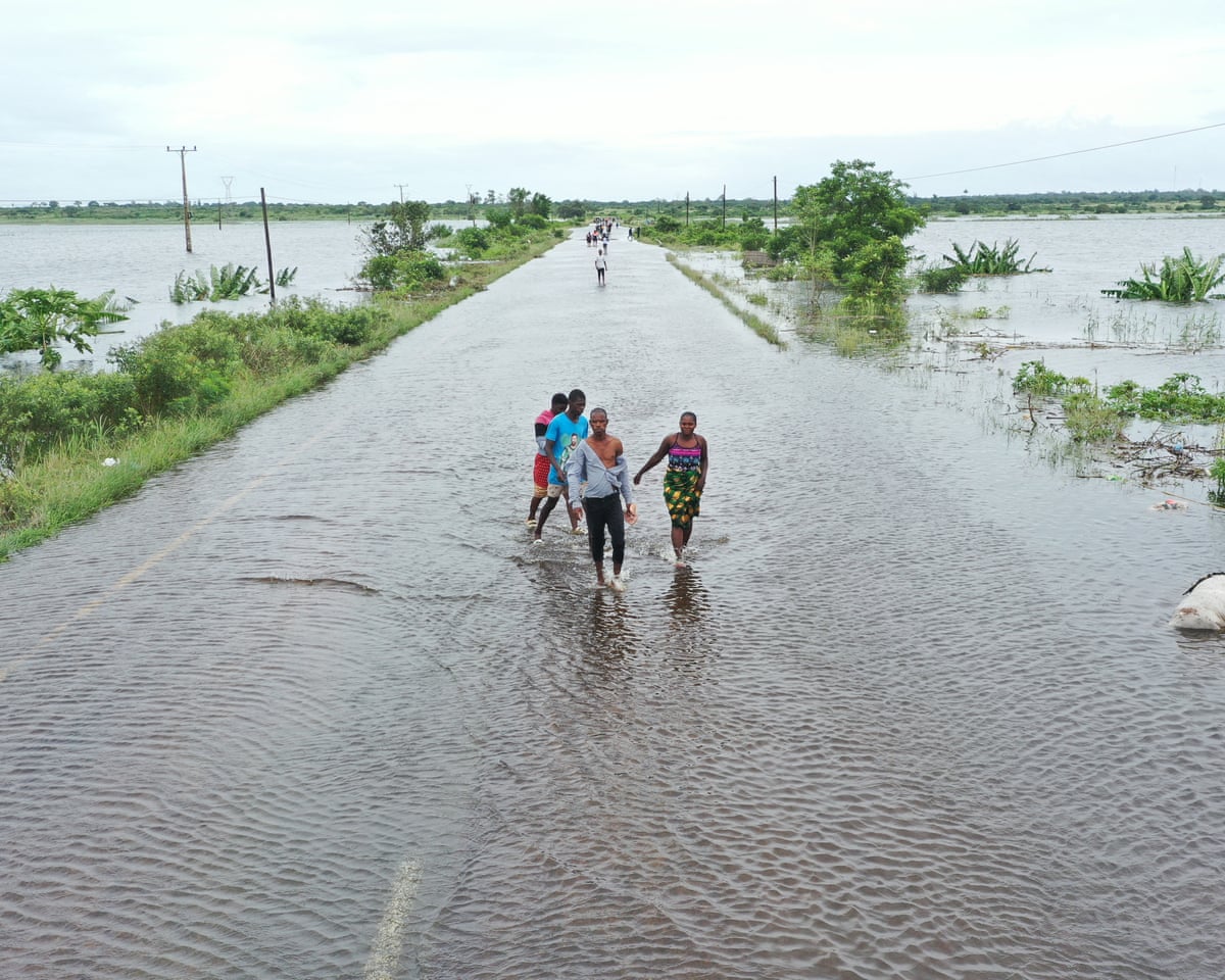 Residents wading through floodwater to cross a road near Maputo, Mozambique, in January.