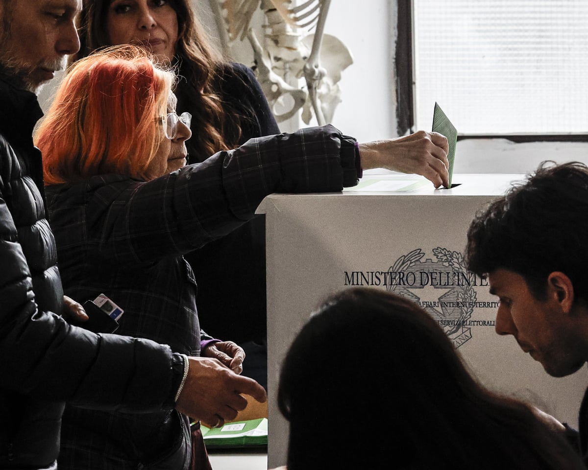 A voter casts her ballot at a polling station in Rome, Italy.
