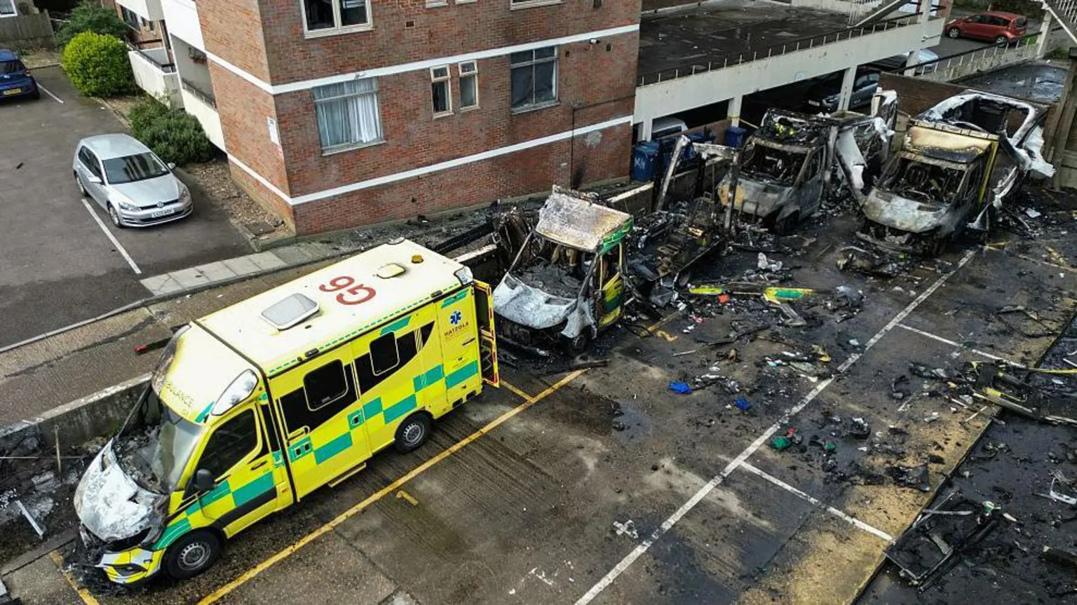  Three completely burnt out ambulances and a fourth partly damaged ambulance in a car park