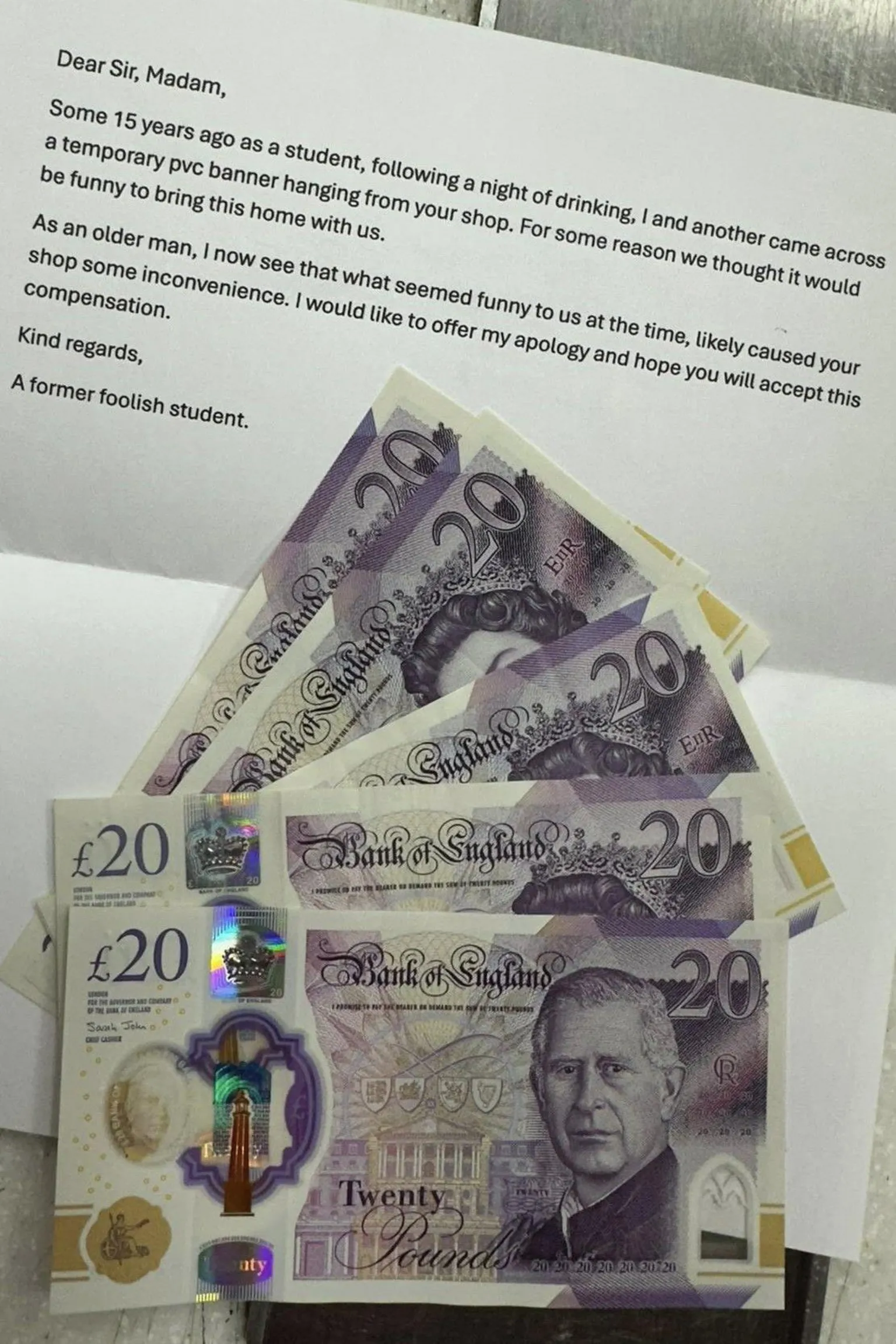 Imran Ashraf A typed letter from the former student, apologising for stealing the sign around 15 years ago. On top of the A4 sheet of paper are five £20 notes. 