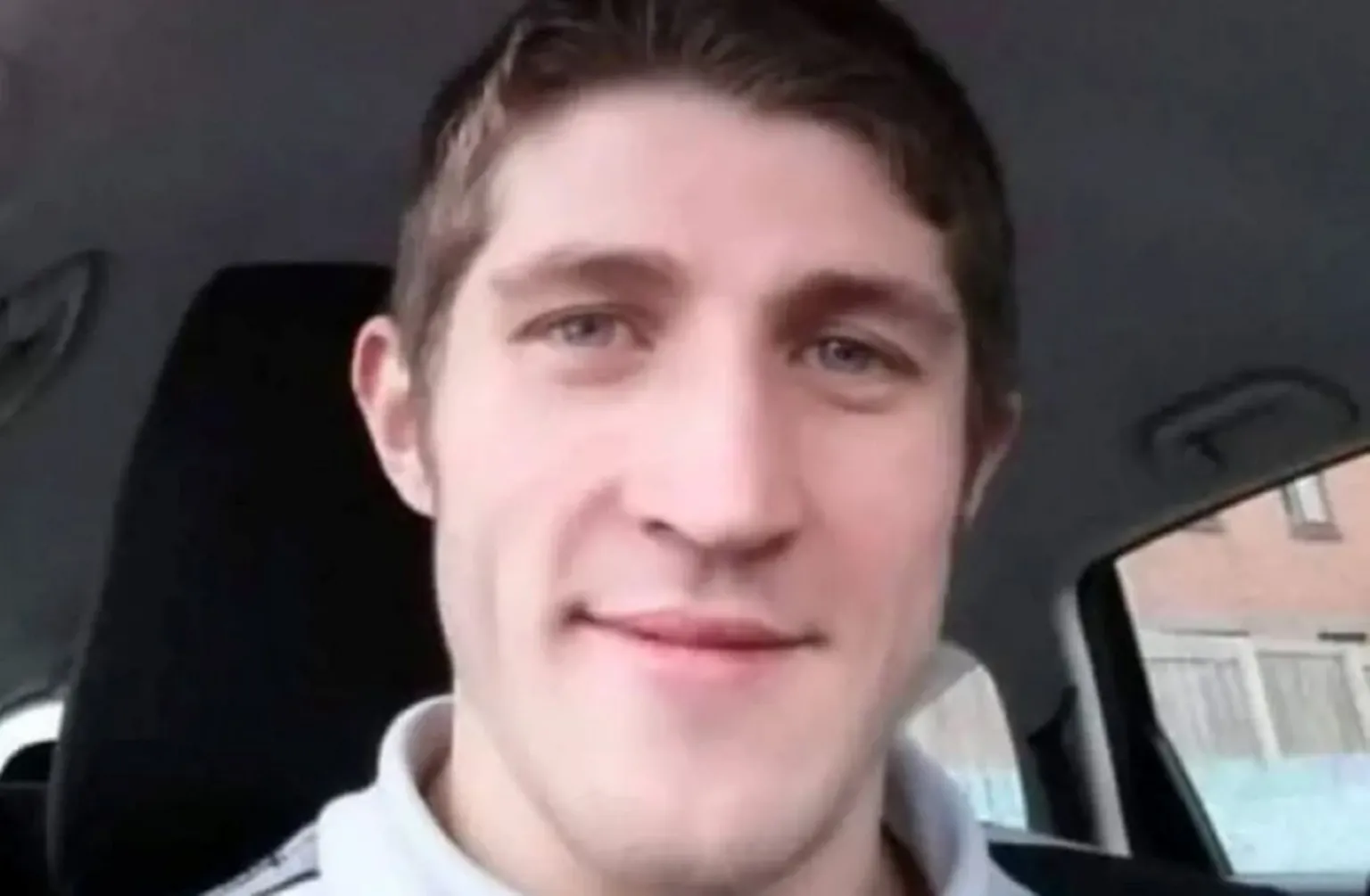 Marshall family A selfie of Allan sitting in a car. He has short brown hair.