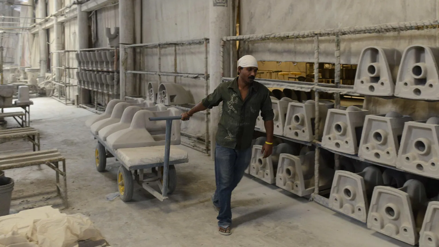  An Indian worker building toilet parts