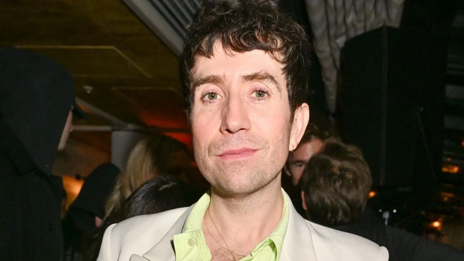  Nick Grimshaw looking directly into the camera wearing a light suit jacket