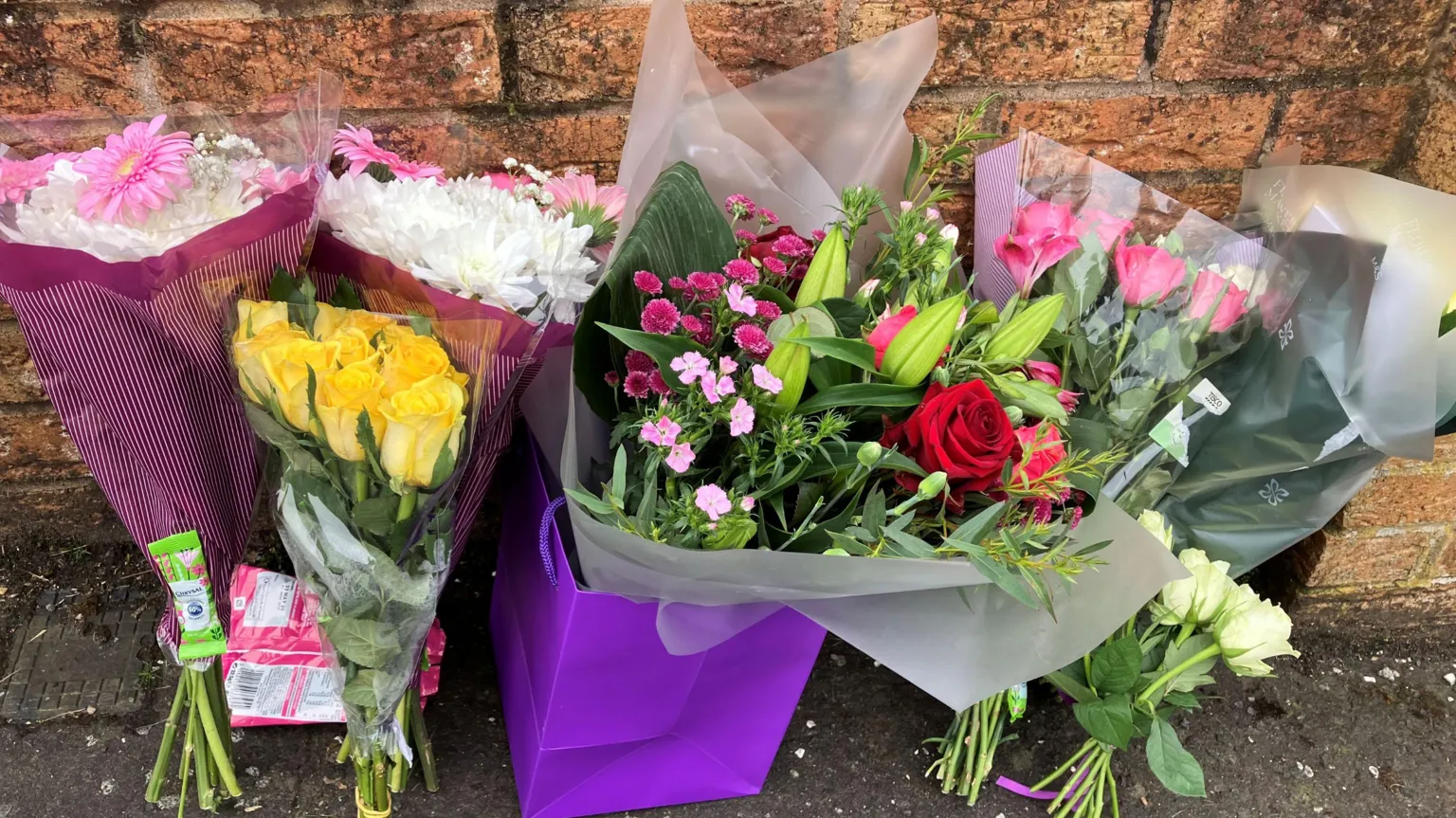 Flowers at the corner of a brick wall