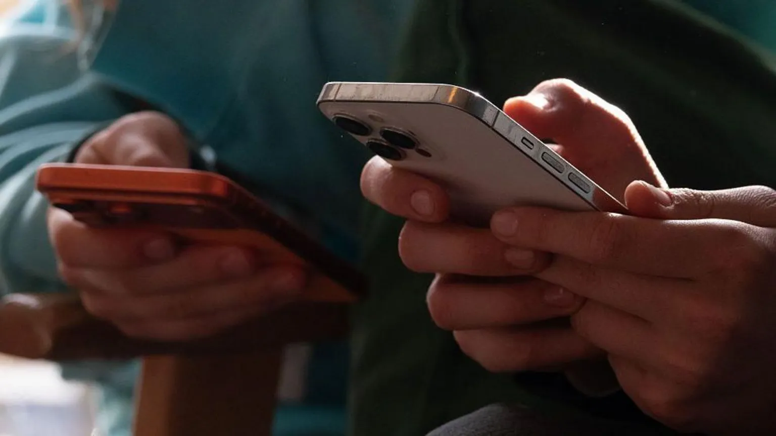 AFP via Two people on their mobile phones