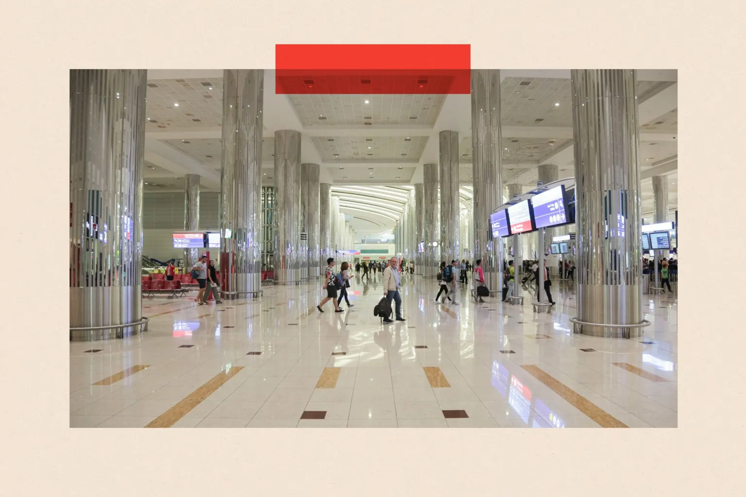 Passengers walk inside of Dubai International Airport