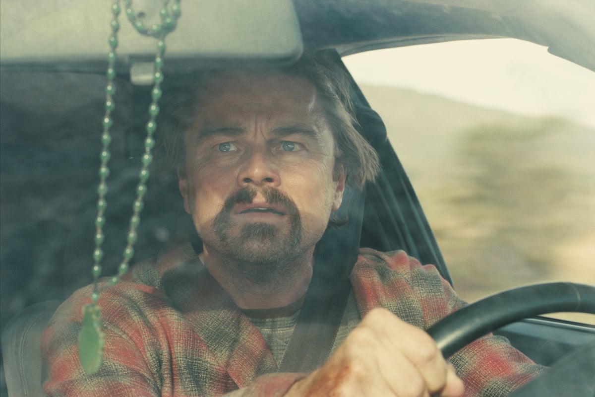 Leonardo DiCaprio behind the wheel of a car looking concerned.