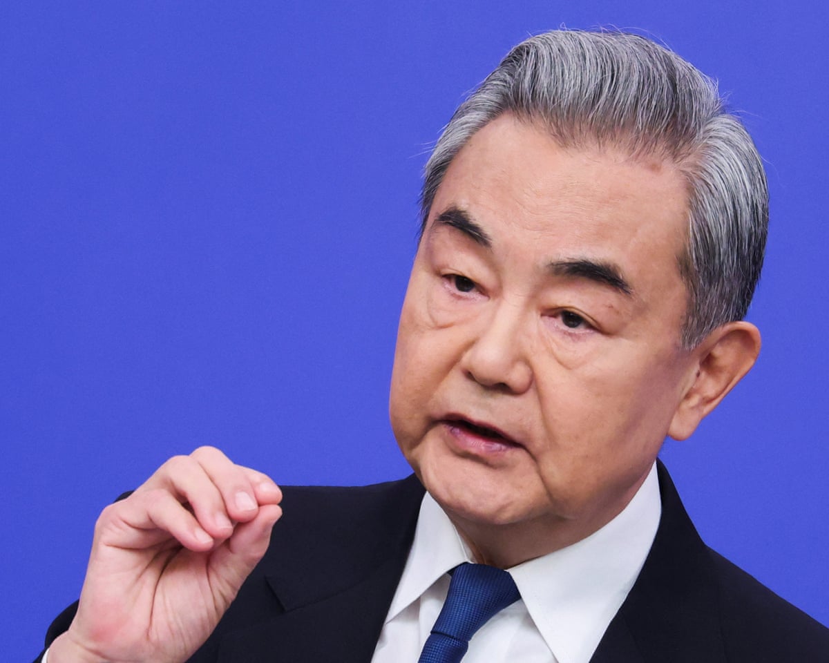 Wang Yi gesturing with his hand as he speaks