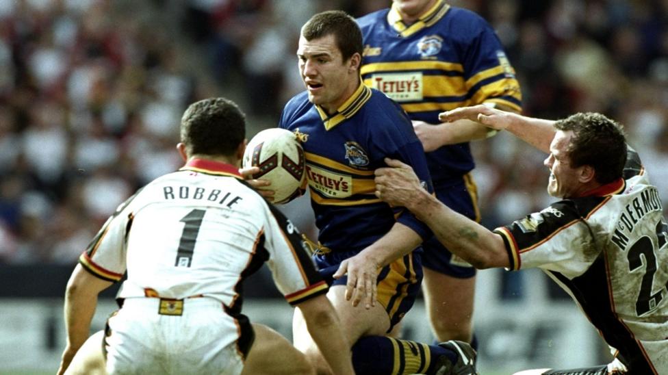Iestyn Harris tries to ride the challenge of a grasping Brian McDermott, while Robbie Hunter-Paul is sizing up a tackle as his opponent closes in during a match between Leeds and Bradford in 1999.