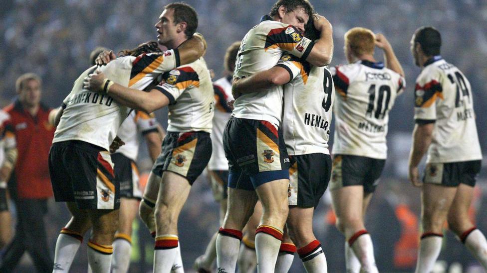 Bradford players embrace after beating Leeds, with Ian Henderson hugging Lee Radford and Lesley Vainakolo mobbed by Jamie Peacock