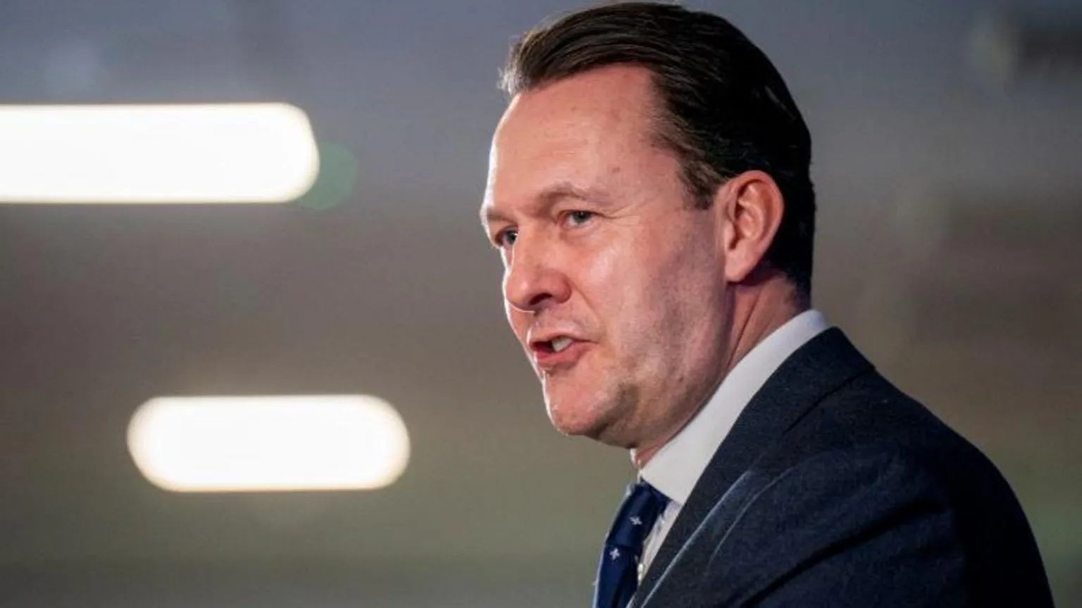  Side view of man speaking at a podium