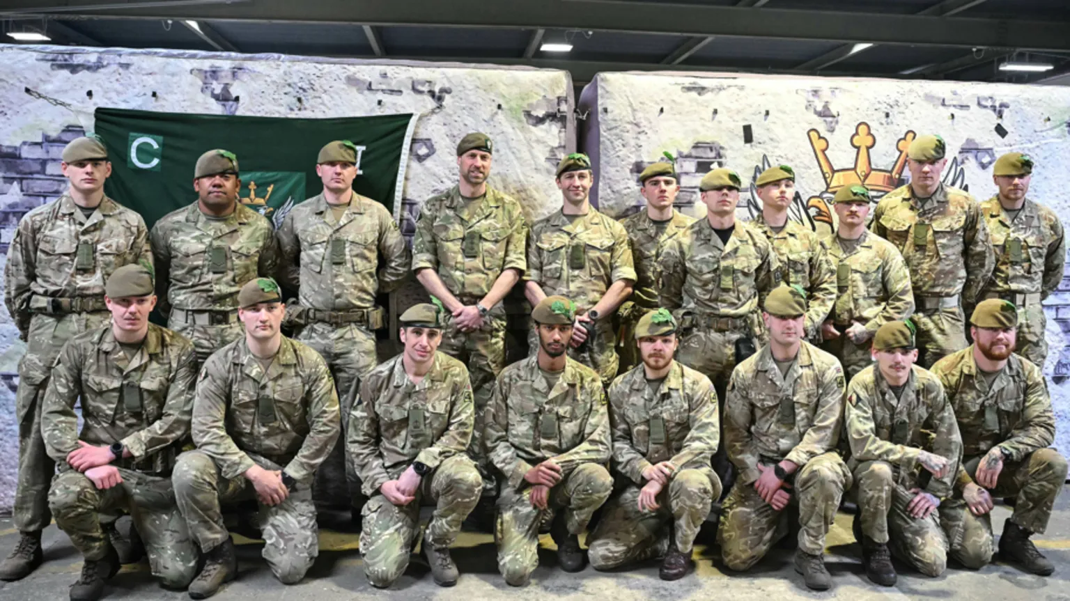 JUSTIN TALLIS/Pool via Soldiers stood together in a group photo. They are all in camouflage gear and Prince William is stood among them on the back row