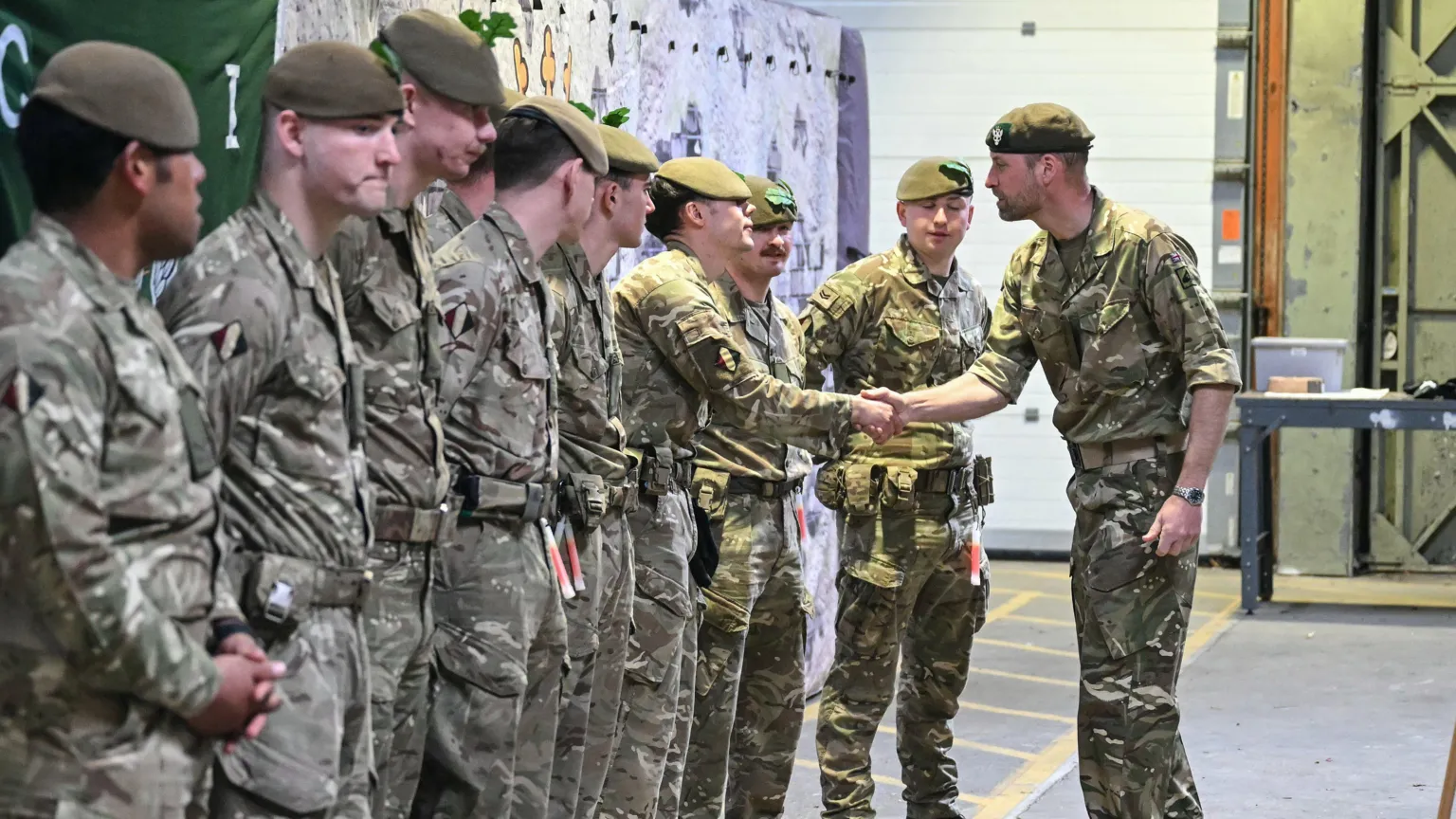 Justin Tallis/PA Wire Prince William shakes hand with a young soldier as other soldiers line up next to him.