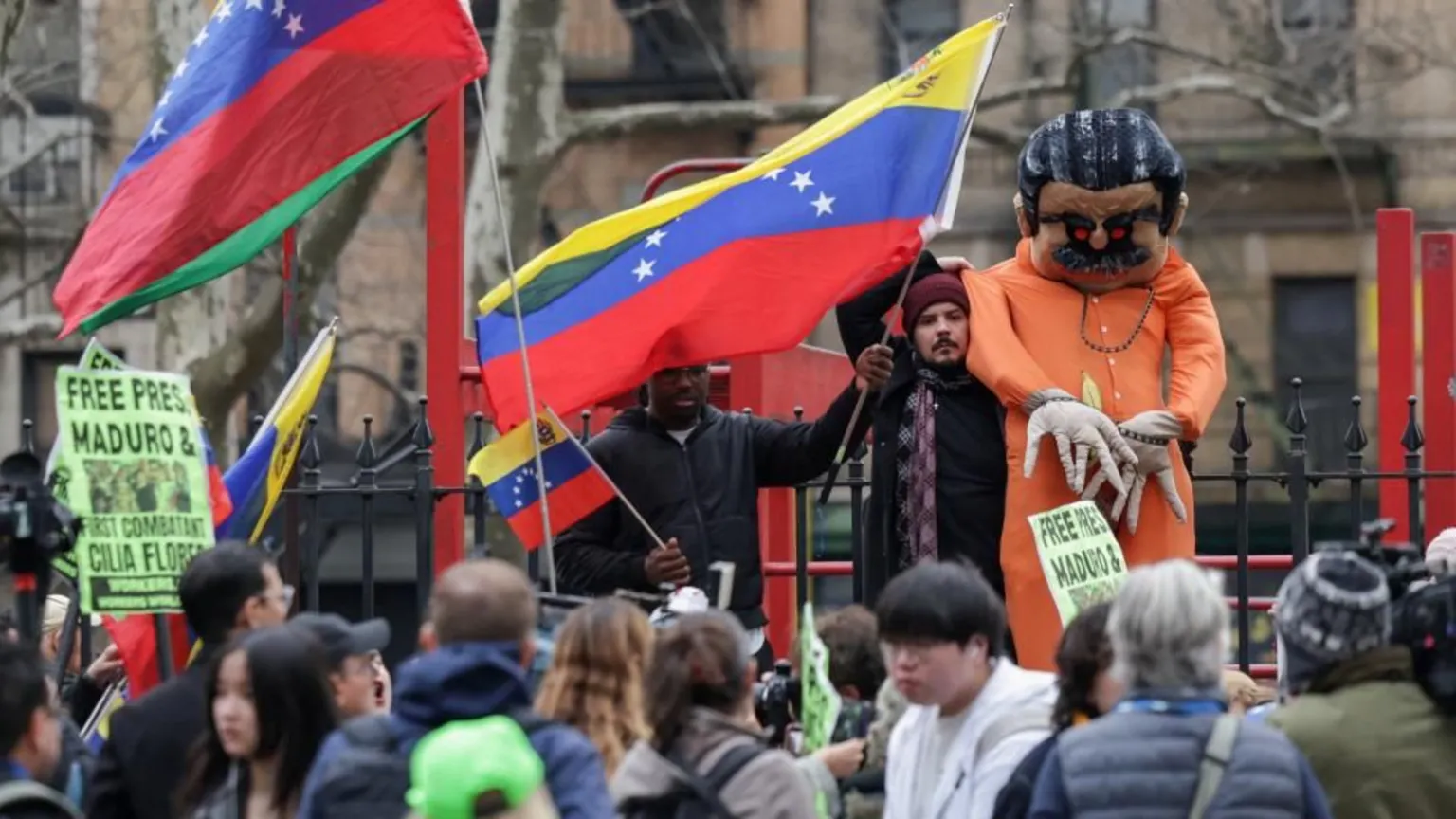  Protesters demonstrate in support of ousted Venezuelan President Nicolas Maduro, many waving Venezuelan flags and 'Free Maduro' signs. A man also holds up a large stuffed maquette of Maduro in prison clothes and chains