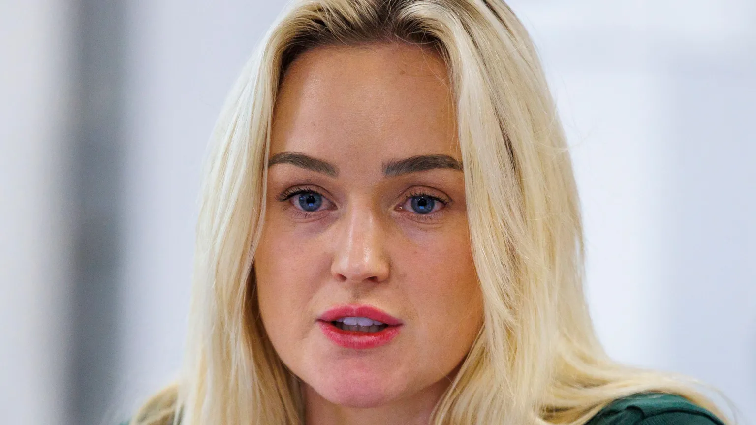  Cheryl Brownlee. She has long blonde hair and blue eyes. She is wearing pink lipstick.