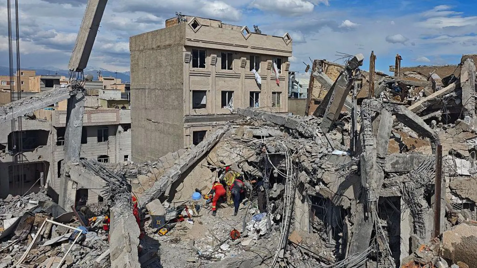  Rescue workers search through the rubble of a building in Tehran, Iran, following an overnight strike. Photo: 28 February 2026. 