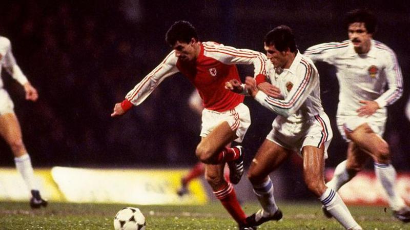 Wales striker Ian Rush fending off a Yugoslavian defender.