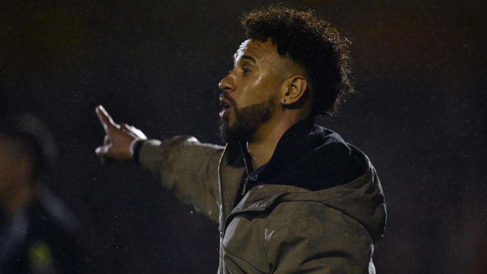Sam Cox points out instructions to his players during a Wealdstone match