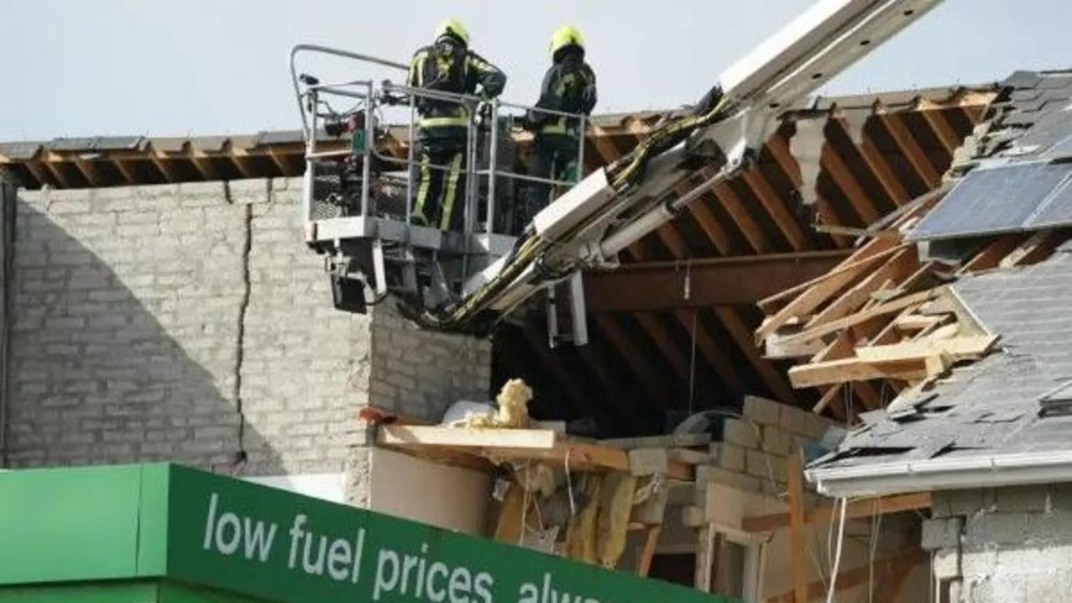 PA Two firefighters are seen near the blast site in October 2022