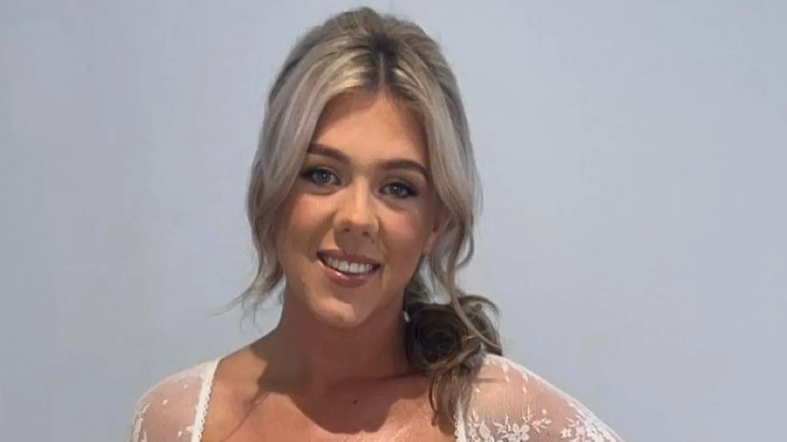 Family handout Amy Doherty who has light blonde hair partly pulled back over her left shoulder, she is wearing a white lace top and smiling at the camera.