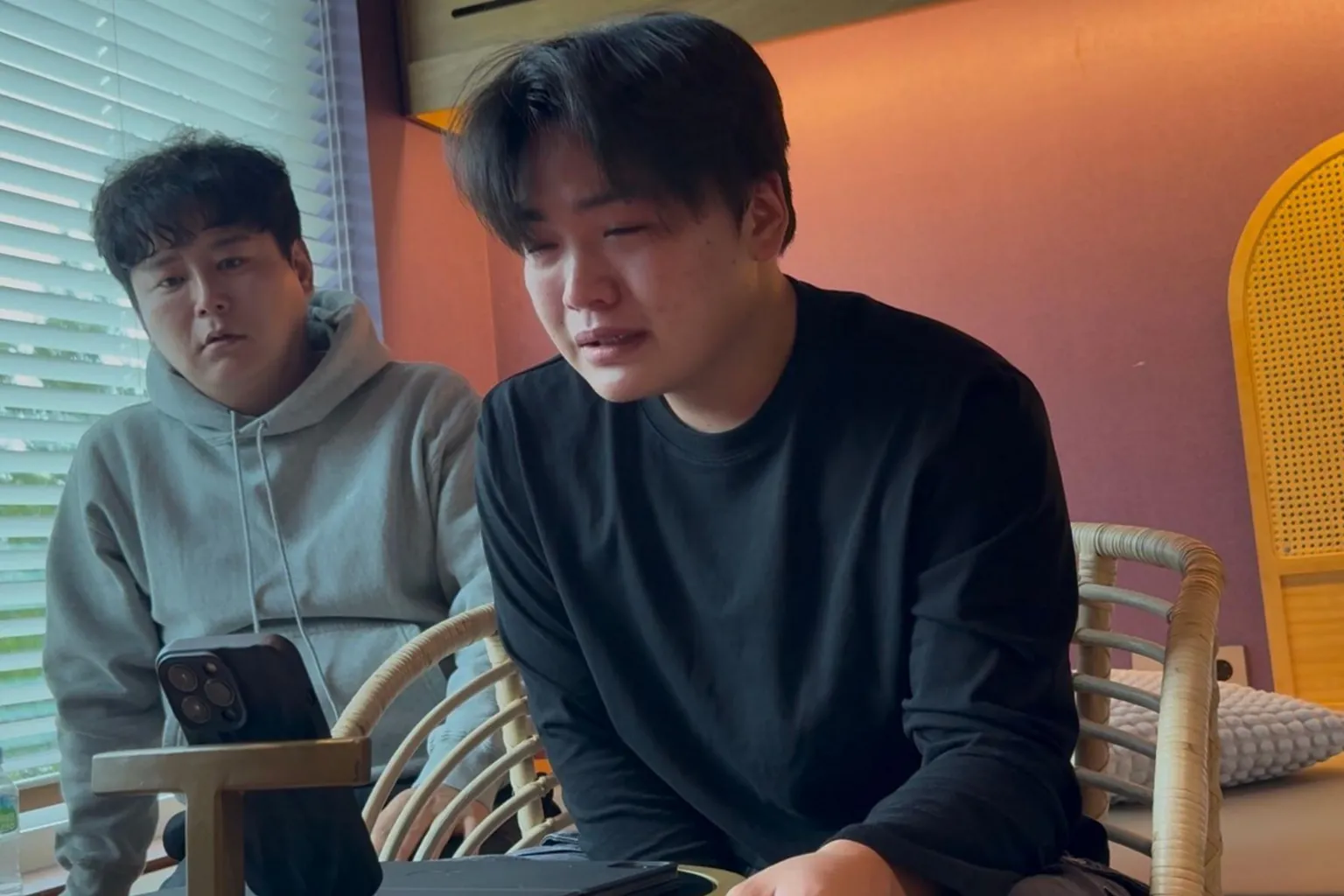 Handout A picture of Geumseong, a 21-year-old North Korean refugee who has fled to Seoul, learning that his mother may soon be repatriated from a Chinese prison to North Korea. His foster father sits behind him