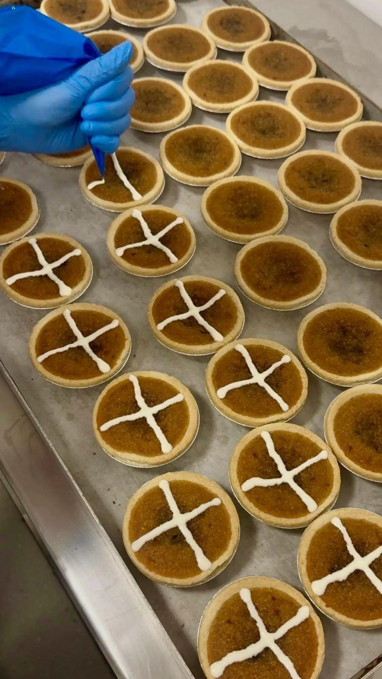 Rows of hot cross tarts being made at Lottie Shaw's bakery.