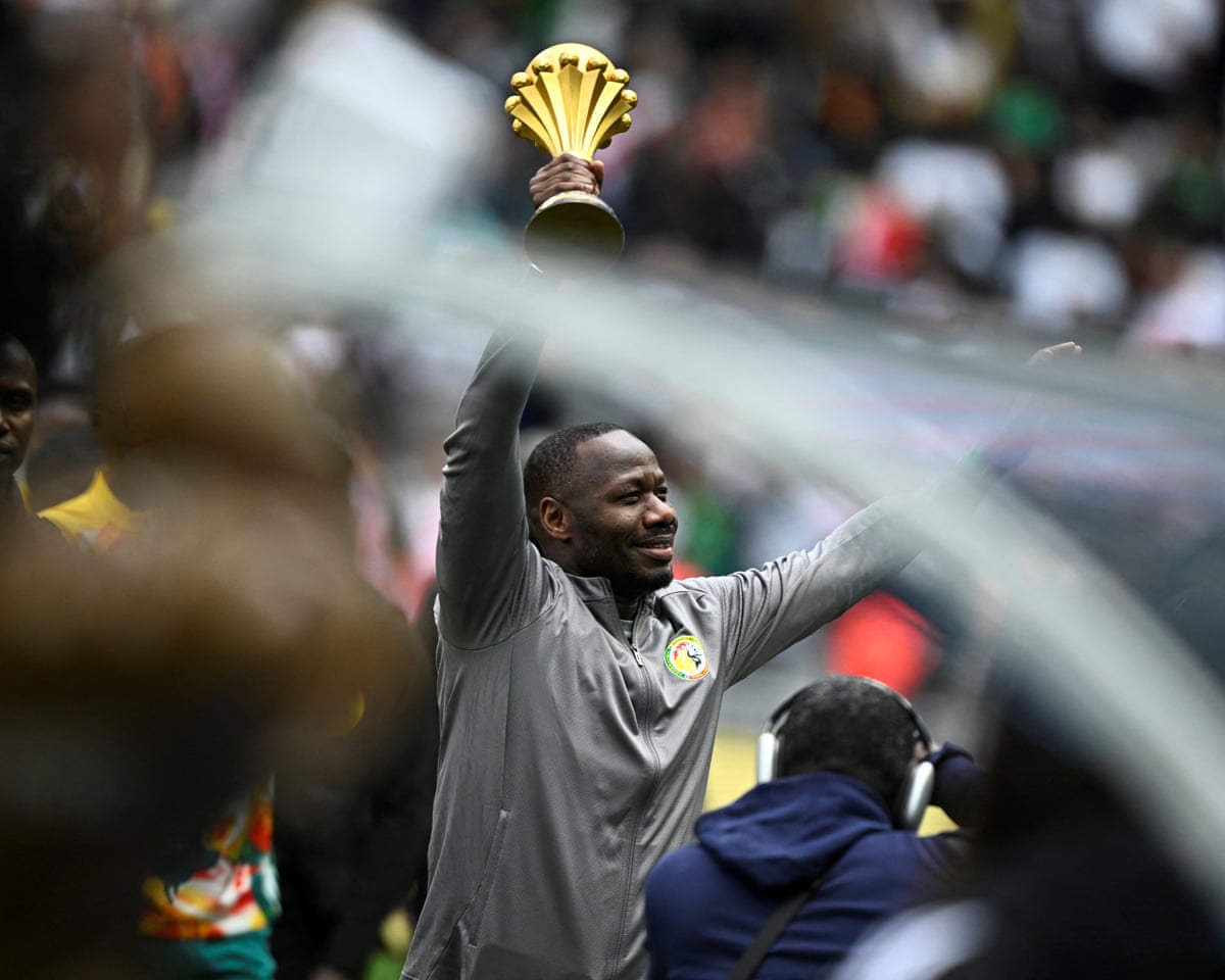 Senegal’s head coach Pape Thiaw holds The African Cup of Nations Trophy